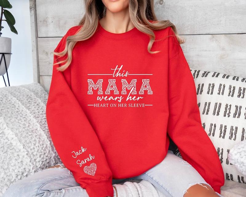 Custom Mama Sweatshirt With Kids Names On Sleeve, This Mama Wears Her Heart On Her Sleeve, Mom Christmas Crewneck Sweater, Mothers Day Gift for Mom